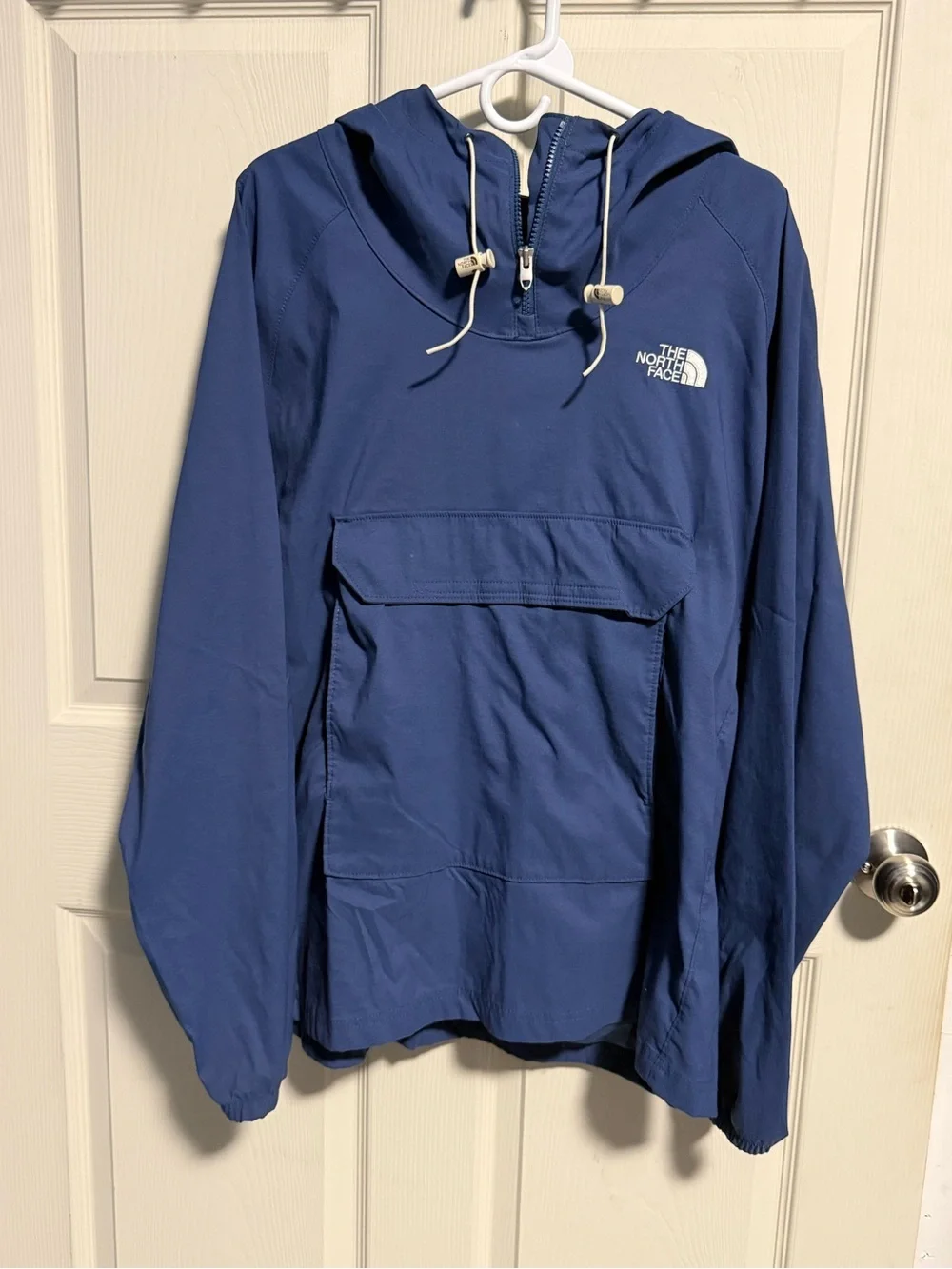 The North Face Navy Blue Men’s Jacket with Black Logo Tag